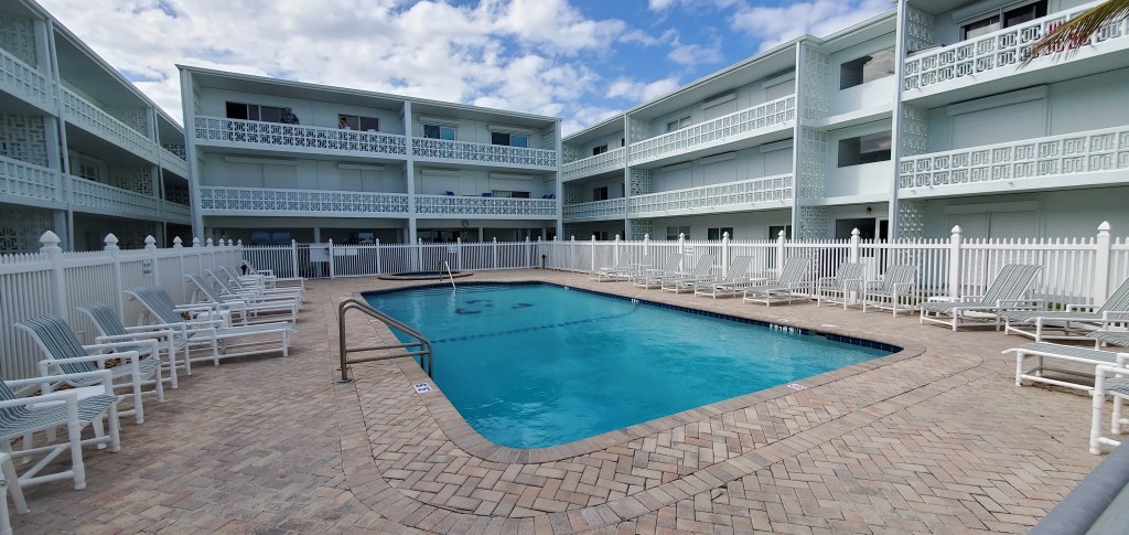 The Atlantique condo has a courtyard pool and balconies overlooking the pool.