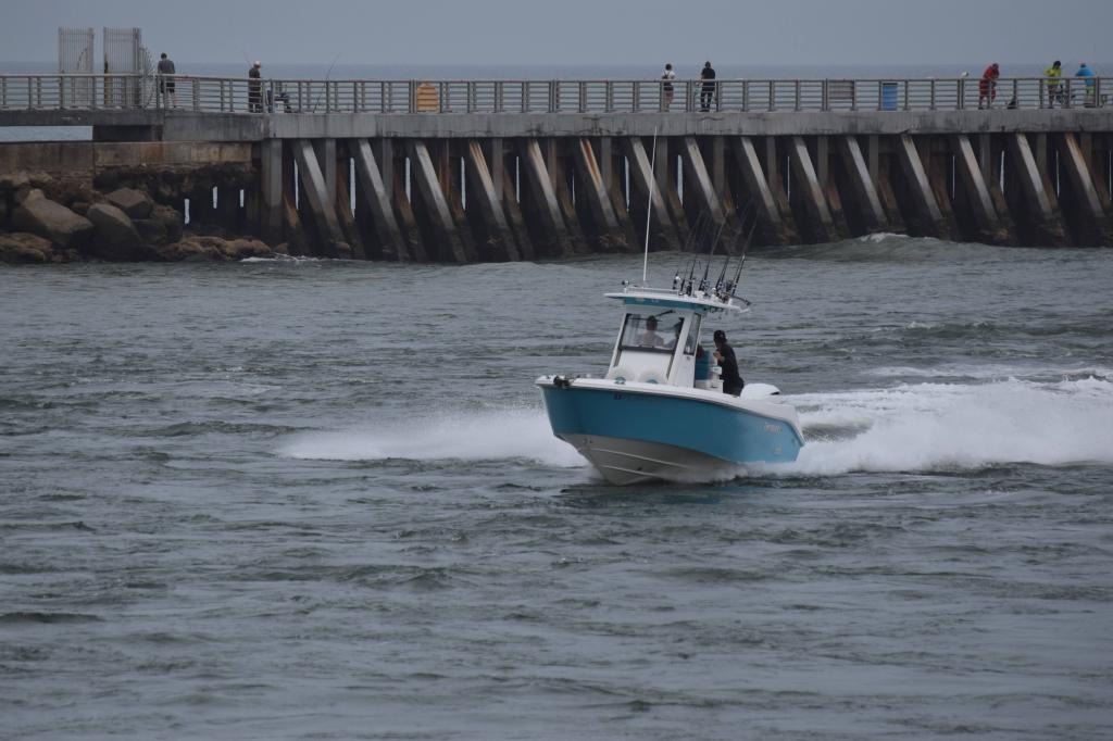 Fishing boat coming through the Sebastian Inlet. The jetty in Sebastian Inlet is in the background