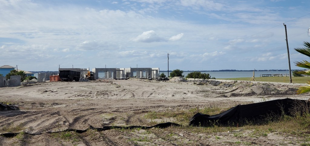South Cocoa Beach site for the Laurham Village community has broken ground. 3 of the riverfront homes are starting to go up. The Banana River is in the background.