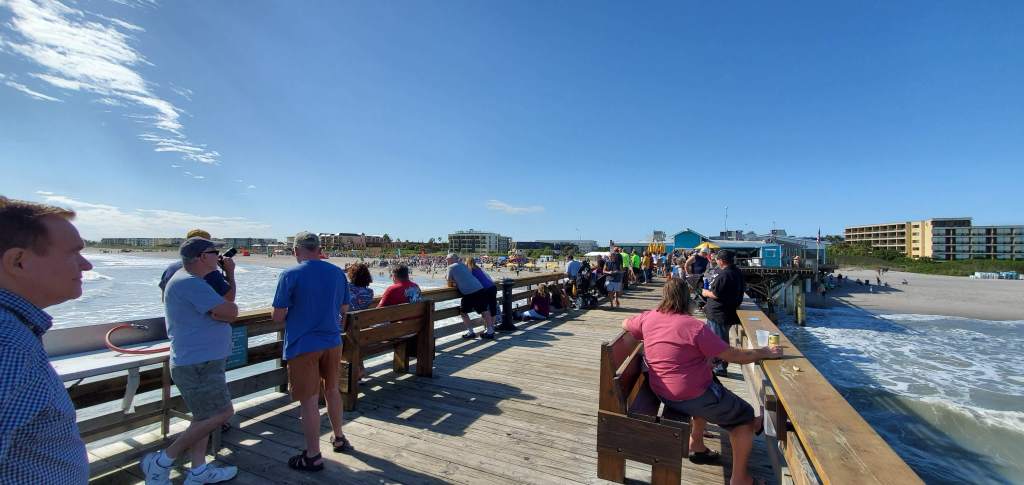 The Cocoa Beach Pier on a sunny day with a lot of people on it