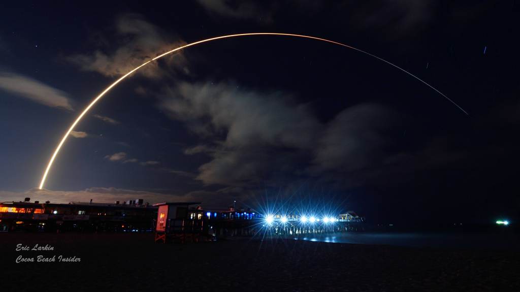 night launch of a SpaceX rocket with the cocoa beach pier in the foreground