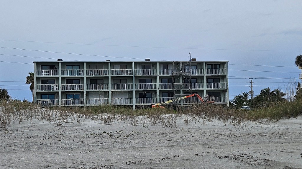 South Cocoa Beach condo with scaffolding going up for concrete work to be completed