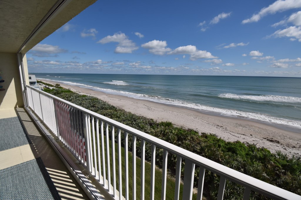 Ocean view from a condo in Satellite Beach. Blue skies with white clouds and small waves breaking