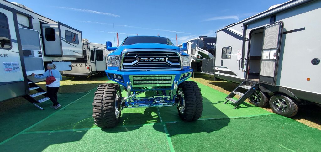 photo of a 4x4 ram truck with RV's on either side. Photo is used as an example of vehicle restrictions in a condo