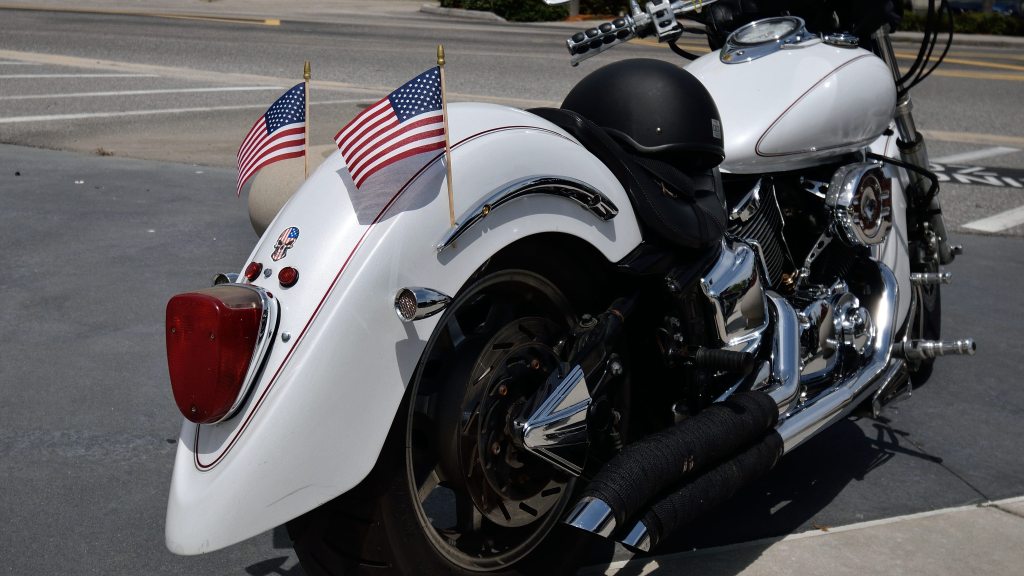 photos of a white motorcycle with american flags. most condos have restrictions regarding motorcycles on the property