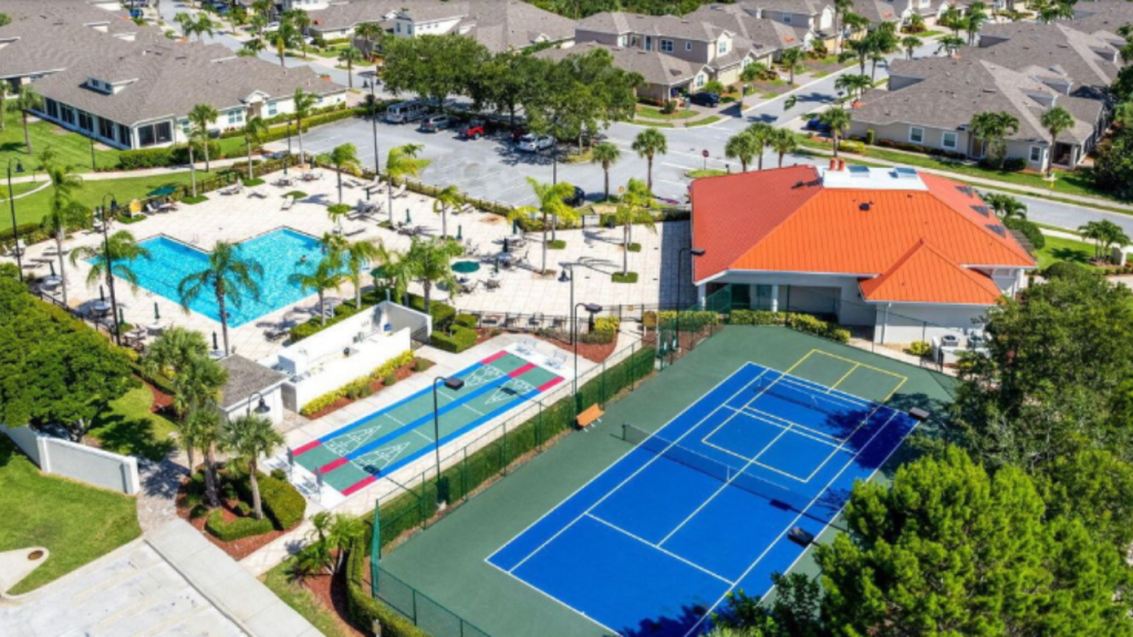 aerial photo of the clubhouse, pool, tennis and shufflboard courts